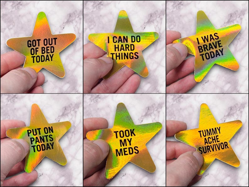 May include: Six gold star-shaped stickers with motivational messages. The messages are: "Got out of bed today", "I can do hard things", "I was brave today", "Put on pants today", "Took my meds", and "Tummy ache survivor".