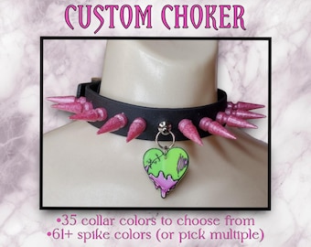 May include: A black choker with pink spikes and a green and pink heart charm. The text "CUSTOM CHOKER" is at the top of the image. The text "35 collar colors to choose from" and "61+ spike colors (or pick multiple)" is at the bottom of the image.