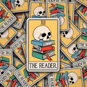 May include: A yellow tarot card with a white skull on top of a stack of books. The card is labeled "XII THE READER."