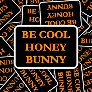 May include: A black background with white borders and orange text that reads "Be Cool Honey Bunny" repeated multiple times.