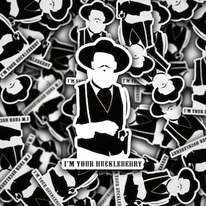 May include: Black and white sticker featuring a cartoon character wearing a vest and hat with the text "I'm Your Huckleberry".