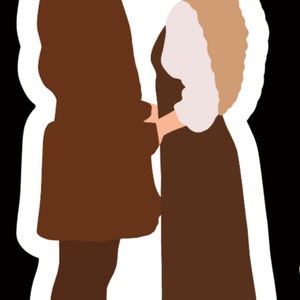 May include: A couple in brown clothing standing close together, looking at each other. The man is on the left and the woman is on the right. They are both wearing brown clothing and have blonde hair.
