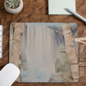 May include: A watercolor painting of a waterfall cascading down a cliff face, framed by two birch trees. The painting is done in shades of blue, green, and brown, with a soft, ethereal feel.