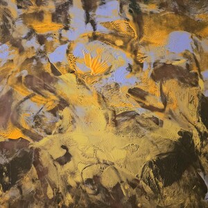 Puede incluir: Pintura abstracta con superficie texturizada. La obra presenta una mezcla de colores, incluyendo tonos marrones, amarillos y azul claro. Las pinceladas crean un efecto din&aacute;mico y en capas, con &aacute;reas de pintura gruesa y textura visible.