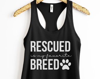 May include: Black racerback tank top with the text "RESCUED is my favorite BREED" in white, along with a paw print graphic. The tank top is hanging on a gold-colored hanger against a white background.