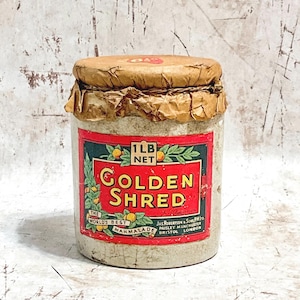 May include: Vintage Golden Shred marmalade jar with a red and green label. The label reads "Golden Shred" and "The World's Best Marmalade." The jar is sealed with a brown paper lid and contains 1 lb net of marmalade.
