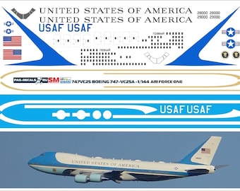 May include: A decal sheet featuring elements for a 1/144 scale model of the Boeing 747-VC25A, also known as Air Force One. Includes text "UNITED STATES OF AMERICA", "USAF USAF", and the model number. The image also shows a photograph of the plane.