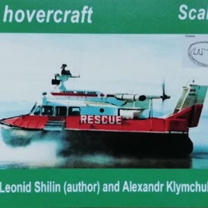May include: A model of an SK-5 hovercraft, painted red and white, with the word "RESCUE" in large letters. The model is shown on a body of water. The text "Scale 1/72" is visible. The project is by Leonid Shilin and Alexandr Klymchuk.