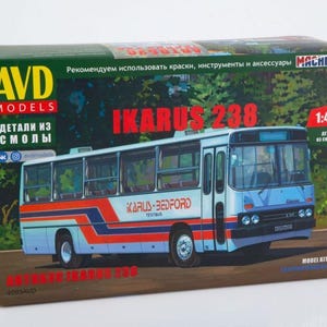 May include: A model kit box showing an Ikarus 283 bus illustration. The box is green, with the bus in blue, white, and orange. Text includes "AVD MODELS" and "IKARUS 283". The scale is 1:43.