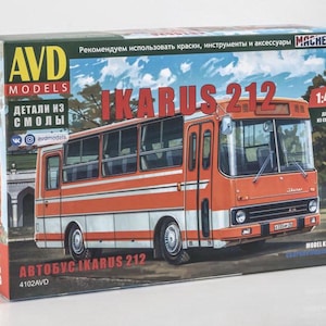 May include: A rectangular cardboard box for an AVD Models Ikarus 212 bus model kit in 1:43 scale. The box features an illustration of an orange and white bus, with the text IKARUS 212, AVD MODELS, and Russian Cyrillic text printed on the front.