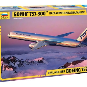May include: A Zvezda 1/144 scale model kit box for a Boeing 757-300 civil airliner. The box features an illustration of a silver passenger jet flying over snow-capped mountains at sunset, with the text Boeing 757-300 clearly visible on the packaging.