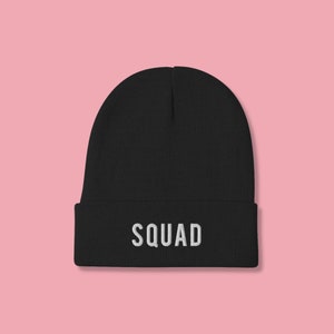 May include: Black beanie with the word "SQUAD" embroidered in white on the front.