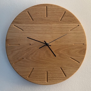 Round wooden wall clock made of oak