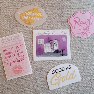 May include: Five stickers with different designs and text. The stickers are on a light brown textured surface. The stickers are pink, yellow, and white. The text on the stickers includes "It's not about the pasta", "Mentally I am here", "Good as Gold", "Rawr in hell", and "I'm not sure what I've done to you but I'll take a pinot grigio".