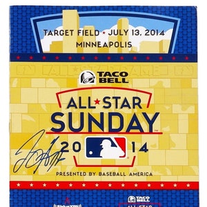 May include: A blue and yellow program for the 2014 All-Star Sunday event, featuring the Taco Bell logo and the text "All-Star Sunday 2014". The program is presented by Baseball America and includes information about the All-Star Futures Game and the All-Star Legends & Celebrity Softball Game.