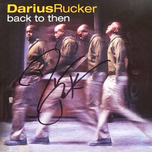 May include: Album cover for Darius Rucker's "back to then." The cover features a blurred image of a man in a green jacket and khaki pants, with a signature across the image. The album title and artist name are in yellow and white text.