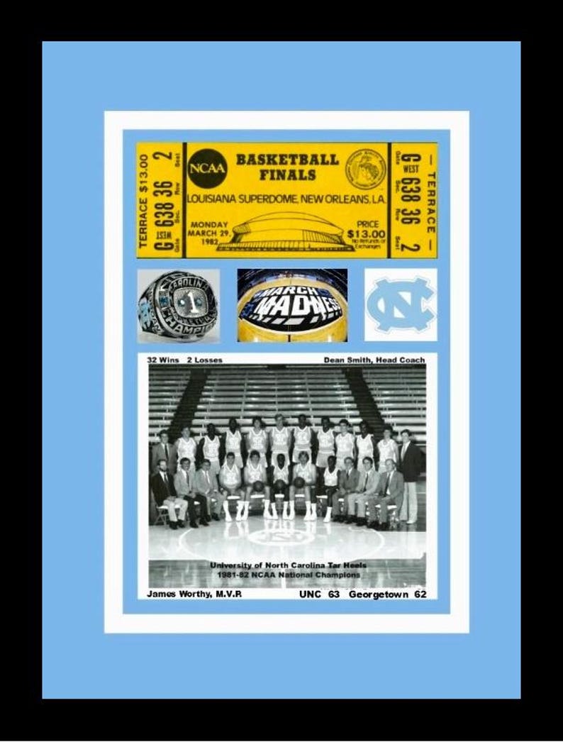 May include: A framed collage featuring a basketball ticket, a championship ring, and a team photo. The ticket is for the NCAA Basketball Finals at the Louisiana Superdome in 1982. The ring says "CHAMPION". The team photo shows the University of North Carolina Tar Heels.