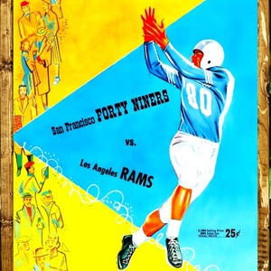 May include: Vintage football poster featuring a player in a blue uniform catching a red football. The poster announces a game between the San Francisco Forty Niners and the Los Angeles Rams on October 4, 1959. The poster has a yellow and blue background.