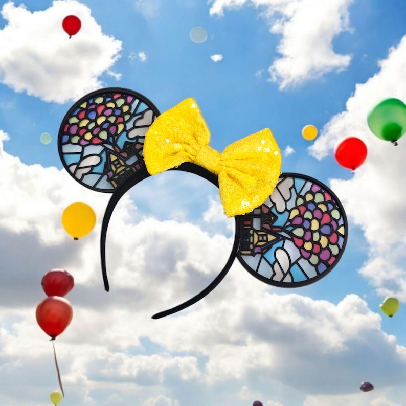 UP-inspired Mickey Mouse ears headband with stained glass balloon and house design, featuring a sparkly yellow sequin bow – colorful Disney Pixar accessory for park visits, Disneybounding, and gift for Disney fans.