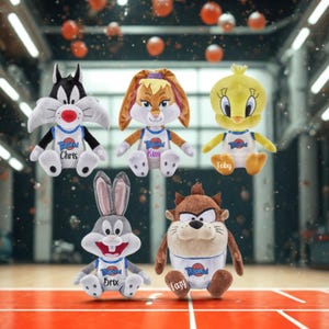 May include: A collection of plush toys featuring Looney Tunes characters. The toys include Sylvester, Lola Bunny, Tweety Bird, Bugs Bunny, and the Tasmanian Devil. Each character wears a basketball jersey with a team logo and a name on the chest.