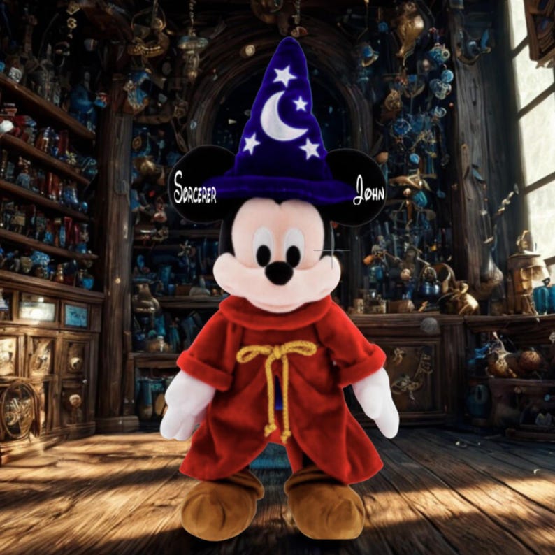 May include: A plush Mickey Mouse dressed as a sorcerer, wearing a blue hat with stars and a crescent moon. He has a red robe with a gold tie. The text "Sorcerer John" is on his ears.
