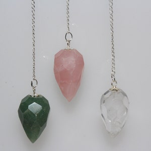 Puede incluir: Tres p&eacute;ndulos de cristal con cadenas plateadas. Los p&eacute;ndulos son facetados y tienen una punta puntiaguda. Los cristales son transparentes, verdes y rosas.