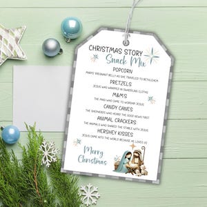 May include: A Christmas gift tag with a grey and white checked border. The tag lists snack mix ingredients and a nativity scene illustration. Text includes "Christmas Story Snack Mix" and "Merry Christmas."
