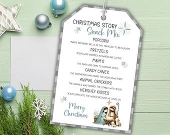 May include: A Christmas-themed gift tag with a gray and white checkered border. The tag lists snack mix ingredients and a nativity scene illustration. Text includes "Christmas Story Snack Mix" and "Merry Christmas."