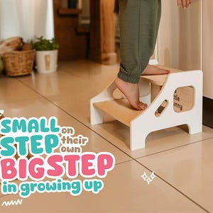 May include: A two-step wooden step stool, painted white with natural wood steps. It features cut-out handles and the text "little bunny" on the side. The text "SMALL STEP BIGSTEP in growing up" is also visible.
