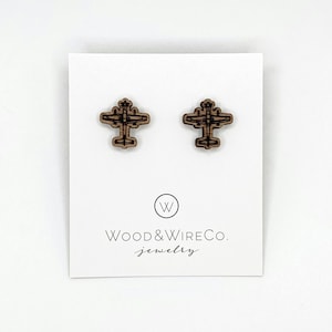 May include: Two wooden airplane stud earrings. The earrings are brown and have a detailed airplane design. The earrings are displayed on a white card with the text "Wood & Wire Co. jewelry".