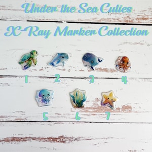 May include: Under the Sea Cuties X-Ray Marker Collection. Seven colorful markers with sea creature designs: turtle, dolphin, whale, octopus, jellyfish, seaweed, and starfish.