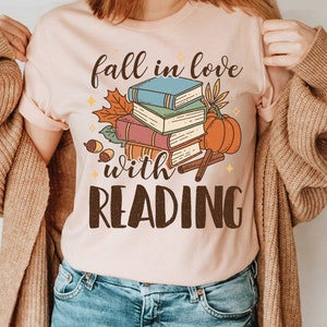  FALL INTO A GOOD BOOK Reader Autumn Reading Books Meme T-Shirt  : Clothing, Shoes & Jewelry