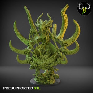 May include: A green 3D printed miniature of a creature with a bird-like head and multiple arms, sitting on a circular base. The creature is surrounded by intricate details and appears to be holding a large, round object.
