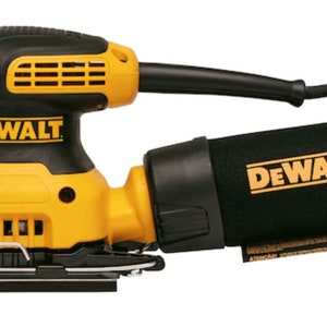 May include: A yellow and black DeWalt random orbit sander with a black dust collection bag. The sander has the DeWalt logo in yellow on the body and the dust bag. The power cord is black.