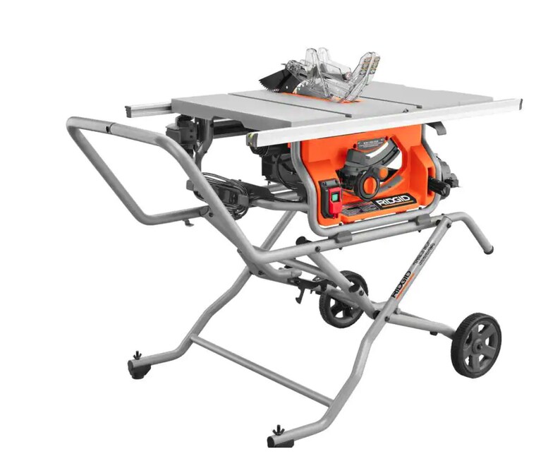 May include: An orange and grey table saw with a silver blade guard and a silver stand. The saw has a black blade and a red power button. The stand has wheels for easy movement. The brand name "RIDGID" is visible on the saw.