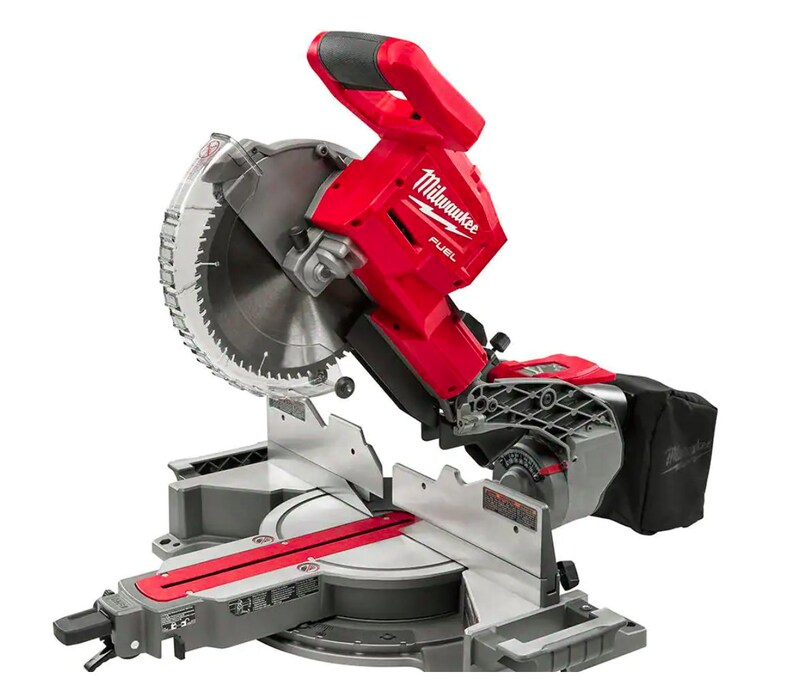 May include: A red and grey mitre saw with a large circular blade. The saw has a black handle and a dust collection bag. The brand name "Milwaukee FUEL" is visible on the motor housing.