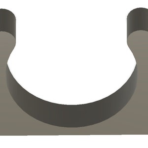May include: A grey plastic pipe clip, U-shaped in design. It features two mounting holes on the base and curved arms extending upwards. This clip is designed to secure a pipe or tube. The clip is made of plastic.