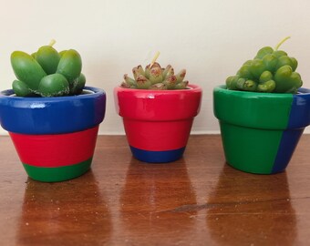 Mini cactus candles in colorful clay pots