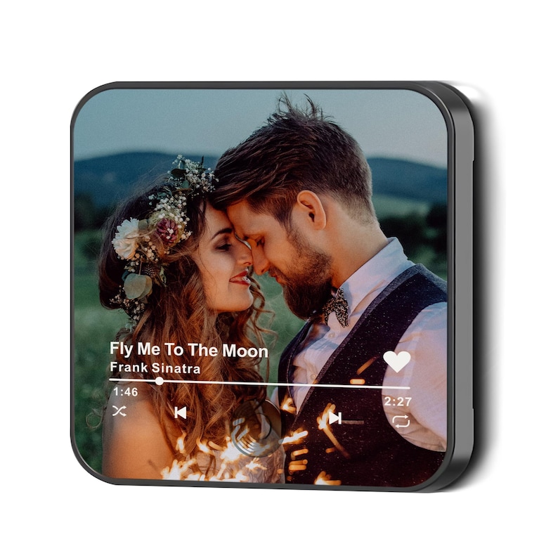 May include: A square, black-edged photo print featuring a romantic image of a couple with the text "Fly Me To The Moon" by Frank Sinatra. The image shows a man and woman embracing, with a music player interface overlay.