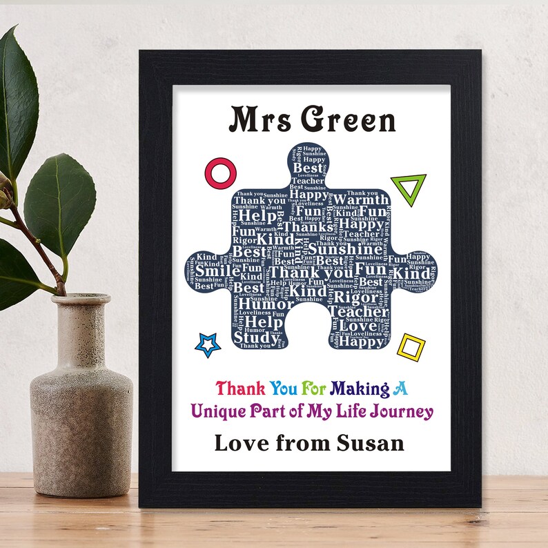 May include: A framed print with a blue puzzle piece design that says "Mrs. Green" at the top and "Thank You For Making A Unique Part of My Life Journey Love from Susan" at the bottom. The puzzle piece is filled with words like "best", "kind", "fun", "happy", "teacher", "love", "help", "rigor", "smile", "sunshine", and "study".
