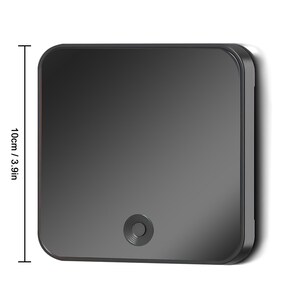 May include: A square, dark gray device with rounded corners, measuring 3.9 inches (10 cm) in height. It features a small, circular button at the bottom center. The device has a smooth, reflective surface.