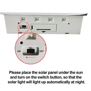 May include: Close-up of a white solar light with an on/off switch. The light has four LED bulbs and a solar panel. The text "ON" and "OFF" is printed on the switch.