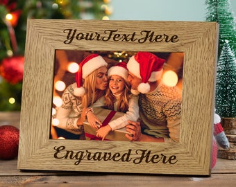 May include: A wooden picture frame with a photo of a family wearing Santa hats. The frame has the text "Your Text Here" and "Engraved Here" on it.