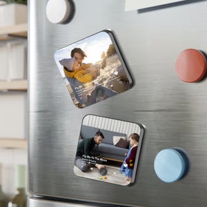 May include: Two square magnets with rounded corners. Each magnet features a photo of a father and child. The text "Fly Me To The Moon" by Frank Sinatra is visible on each magnet, along with a music player interface.