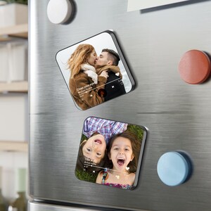 May include: Two square magnets with rounded corners. One magnet shows a couple kissing with the text "Close your eyes" and a music player interface. The other magnet shows two children smiling with the text "Title song" and a music player interface.