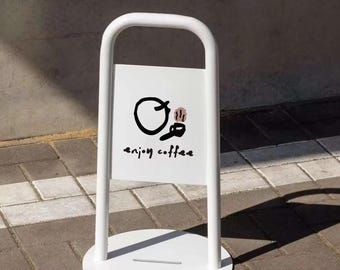 May include: A white metal A-frame sidewalk sign with a rounded top and a circular base. The central rectangular panel features a black hand-drawn circular logo, a small brown coffee cup icon, and the black handwritten text "enjoy coffee".