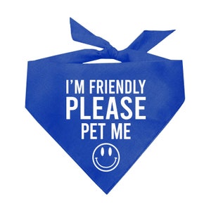 May include: Blue dog bandana with white text that says "I'm Friendly Please Pet Me" and a white smiley face.