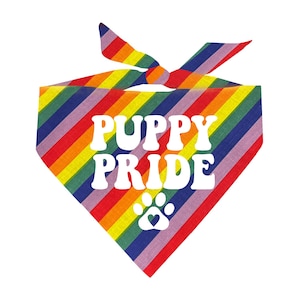 May include: Rainbow bandana with the text "Puppy Pride" in white and a white paw print with a heart in the center.