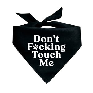 May include: Black dog bandana with white text that reads "Don't F*cking Touch Me" with a paw print in the middle. The bandana is tied at the top.