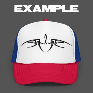 May include: A trucker hat with a white front panel featuring a black abstract design. The hat has a red brim, a blue mesh back, and the word "EXAMPLE" in white block letters above the hat.